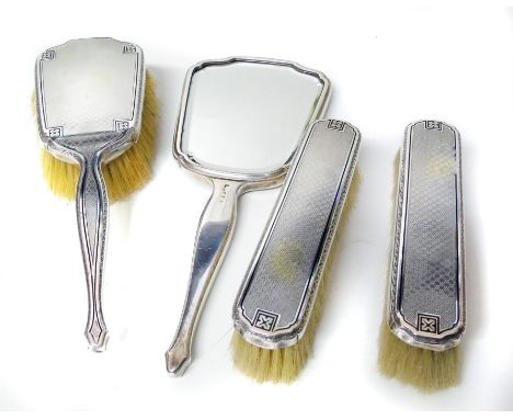 A silver backed engine-turned dressing table sale, comprising a brush, two other brushes and a mirror Condition reports canno