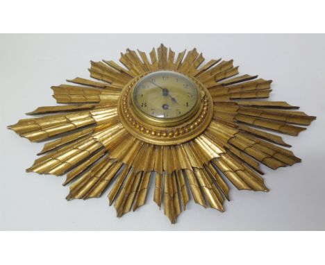 Gilt framed sunburst wall clock with electric movement Condition reports cannot be done for our Interiors sales.
