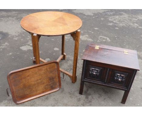 An early 20th century fold away circular card table, small oak tray, miniature carved oak blanket chest Condition reports can