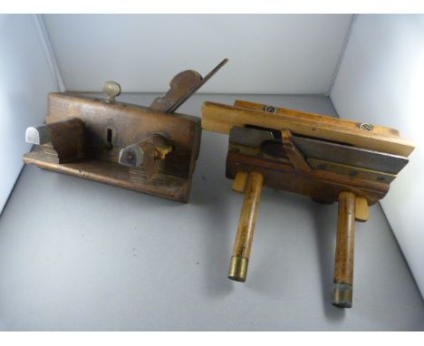 A pair of vintage woodworking tools with brass features