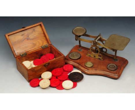 A MIDDLE EASTERN OLIVE WOOD BOX, 13cm wide; and a set of brass postal scales and weights on a serpentine base, 19cm wide (2 +