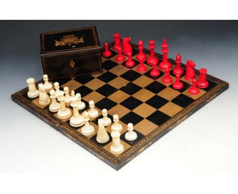 AN OLD IVORY CHESS SET contained within a black lacquered box with figure decoration, 15cm wide; together with a folding lacq