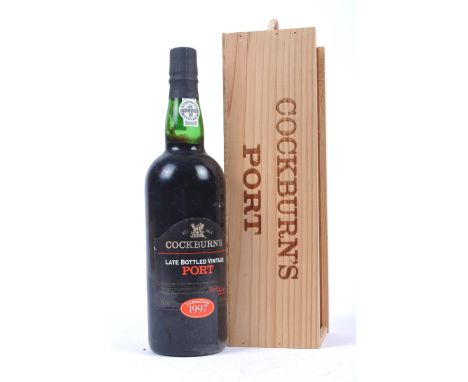 A single boxed bottle of Cockburn's 1997 LBV Late Bottled Vintage port. Held within a wooden case presentation box.