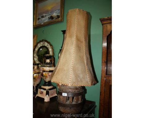 A heavy Oak and metal cart-wheel hub based Table Lamp with parchment shade.