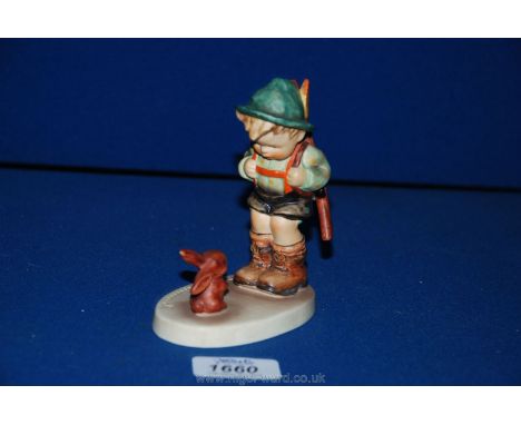An M.J Hummel Goebel figure of a small boy hiking and a rabbit.