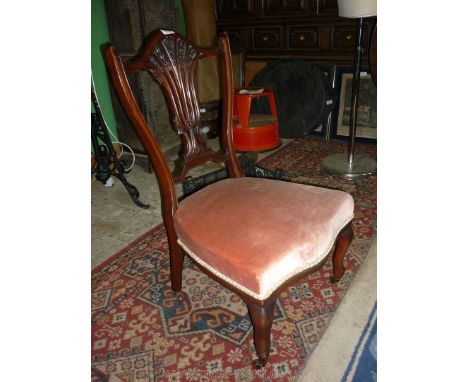 An elegant Edwardian Nursing Chair having delicate pierced and carved splat and standing on bracket, cabriole front legs.
