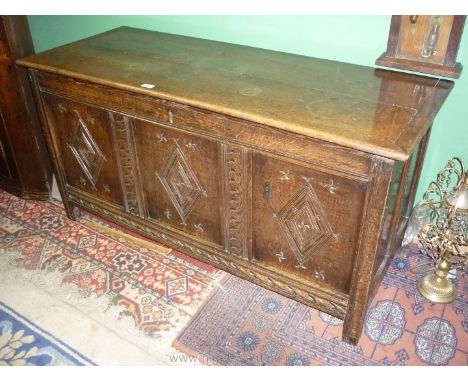 A lovely peg-jointed Oak three panel Coffer, the front panels having diamond shaped carved features and framing, superbly ric