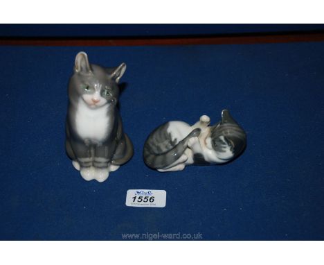 Two Royal Copenhagen Cats, one sitting and one on her back playing, 1025/727.