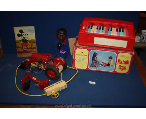A vintage remote control Ford 4000 HD industrial tractor and a toy portable organ, etc.