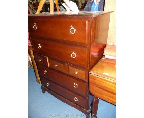 A Stag dark Mahogany Tallboy of four long and three short drawers and standing on bracket feet, 32 3/8" wide x 18 1/8" deep x