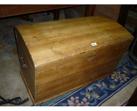 A domed top tapered Pine Trunk/Blanket Chest having wrought iron carrying handles, 31 1/2" long x 17 3/4" deep x 20" high.