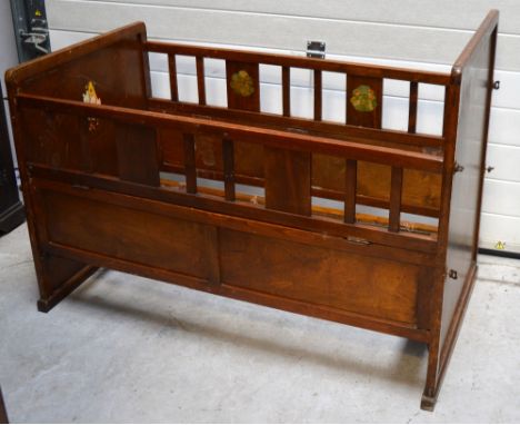 A vintage wooden child's cot decorated with animal scenes, length 120cm.