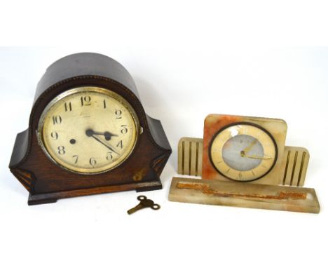 A mid 20th century Enfield oak cased mantel clock the metal dial set with Arabic numerals and a small Art Deco style onyx man