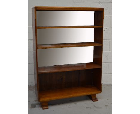 A retro mirror backed four shelf bookcase of simple form, width 90cm (af).