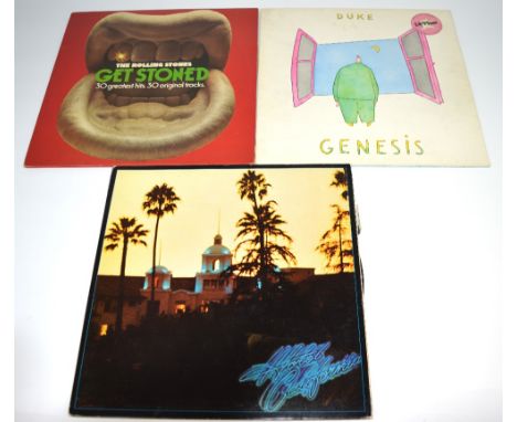 A scrapbook with various newspaper articles featuring the Dennisons, cuttings of various pop stars, vinyl LPs to include Roll
