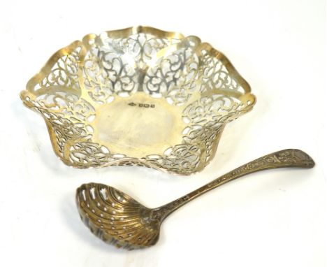 A George V hallmarked silver pierced bon-bon dish, Sheffield 1935, approx 3.2ozt and a silver plated sifting spoon (2).