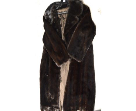 A vintage lady's dark brown fur full length coat.