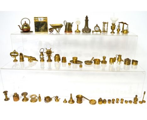 A collection of brass miniature objects to include a canon, an hour glass, an anniversary clock, an oil lamp etc.