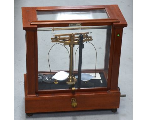 A set of L. Oertling of London brass scales in glazed display case.