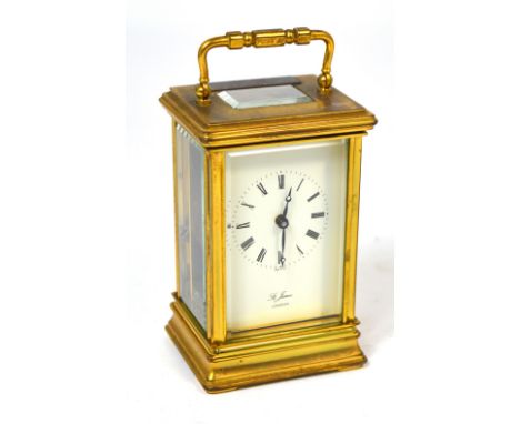 A St. James London brass carriage clock the enamel dial set with Roman numerals, plaque to the top inscribed 'Presented by U.