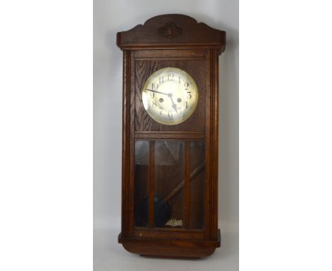 A 20th century oak cased wall clock, silvered dial set with Arabic numerals, 78cm.  