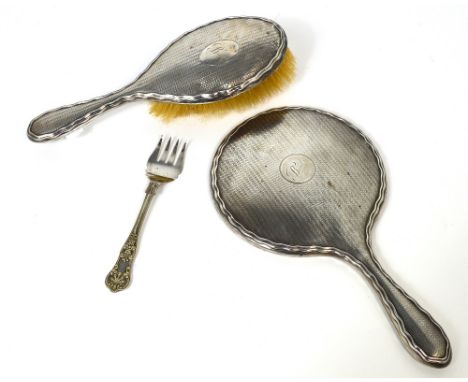 A George V hallmarked silver hand mirror and brush set, both Birmingham 1911, and a silver plated fork.