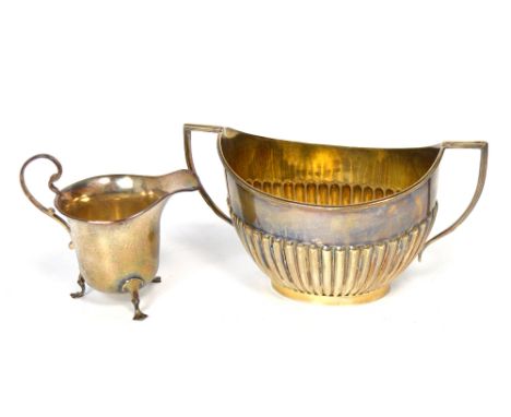 A George V hallmarked silver twin handle basin, Sheffield 1912, and a George V hallmarked silver jug raised on three feet, Bi