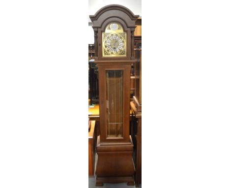 A reproduction mahogany cased long case clock, dome top above gilt metal decorated dial set with Roman numerals and inscribed