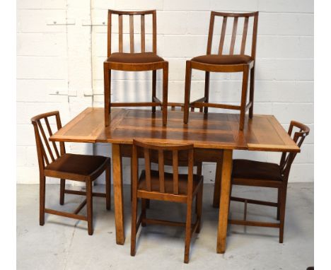 A mid 20th century dining table and six stick back dining chairs (7).