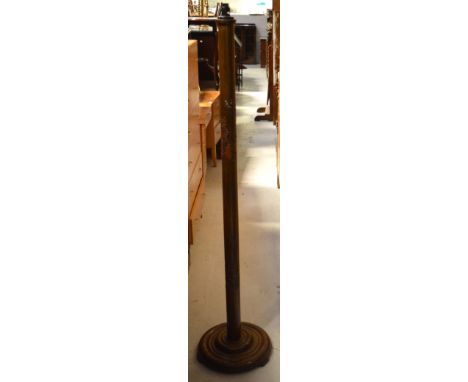 An Oriental carved hardwood standard lamp with a cream embossed lamp shade.