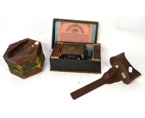 A boxed 'The Standard Magic Lantern' together with slides depicting comical scenes and children, a c.1900 stereoscope and a 1