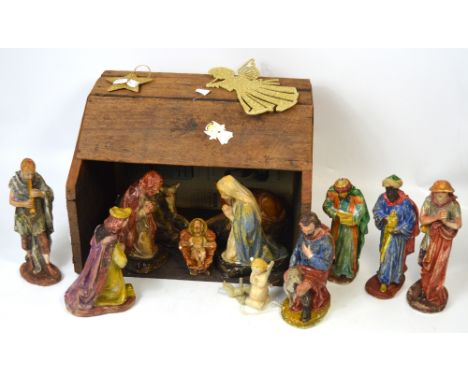 A vintage scratch built nativity scene with plaster figures of the infant Jesus, Mary, Joseph, various animals, shepherds, th