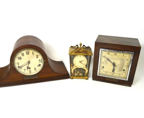 A Goldsmiths & Silversmith Co. chiming mantel clock the square silvered dial set with Arabic numerals above presentation plaq