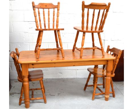 A modern pine kitchen table, width 152cm and a set of four pine stick back chairs (5).