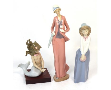 Two Nao figures, a young lady holding a cat and umbrella, a young girl with curls wearing a bonnet and holding a purse and a 