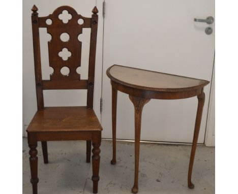 An oak hall chair with finial mounted supports and front ring turned legs and a 20th century walnut glass topped demi-lune oc