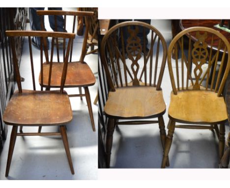 A pair of Ercol stick back chairs on rounded tapering legs and a pair of country style wheel/stick back dining chairs (4).