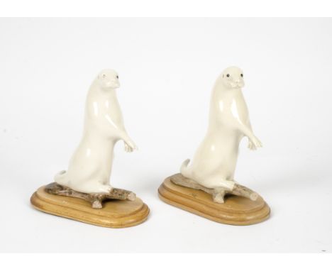 A pair of ceramic stoats with outstretched arms, English naturalistic pottery tradition, standing 22cm tall (2)
