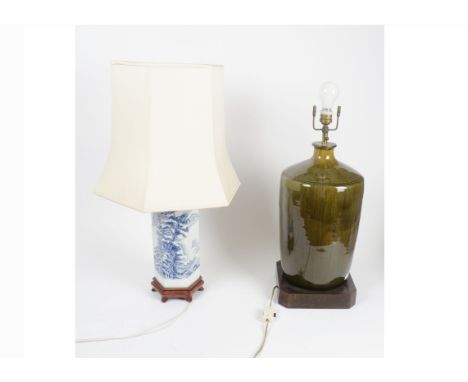 Two ceramic lamp bases, one with blue and white ceramic body with hexagonal shape on hardwood stand, the depiction being a ro