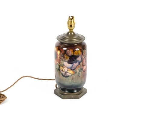 A Moorcroft ceramic lamp base of cylindrical shape with anemone design under a flambe glaze, metal top, to be earlier 20th ce