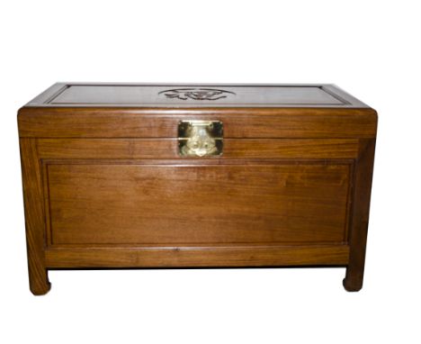 A Chinese camphor wooden trunk, the plain oblong rising top with a central carved Chinese character over plain sides on short