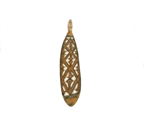 An Asmat gope board with orange and white paint and head finial, Papua New Guinea, 86cm long  