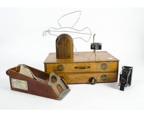 A French mahogany card dealer's shoe, by JCST &amp; Cie, Paris, with a 1930's oak table top haberdashery cabinet for 'Sphere 