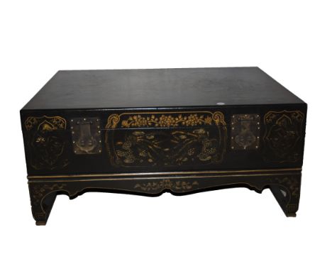 A Chinese leather trunk near square outline painted with figures, with drop handles, raised on a separate base and short legs
