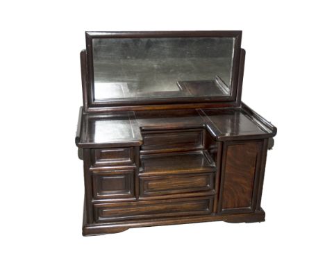 A Chinese padouk wood table top cabinet having a swing mirror over an inverse top with six various drawers on panel feet, wid