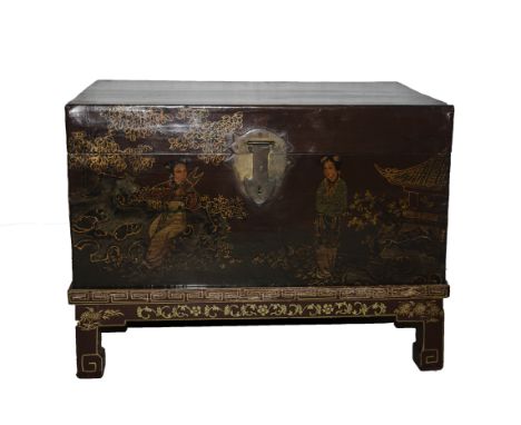 A Chinese scarlet ground trunk decorated with figures in gardens with pavilions, on a matching stand with short square sectio