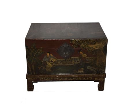 A Chinese scarlet ground trunk decorated with figures in gardens with pavilions, on a matching stand with short square sectio