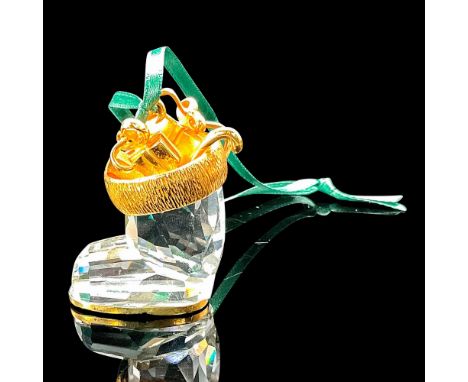 Christmas ornament of faceted clear crystal finished with gold-colored metal, interior decorated with Christmas presents, can