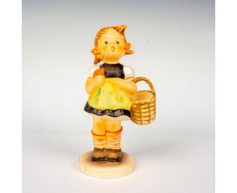 Hand painted in matte finish modeled as a German girl carrying a basket. M. I. Hummel impressed backstamp. Goebel backstamp. 