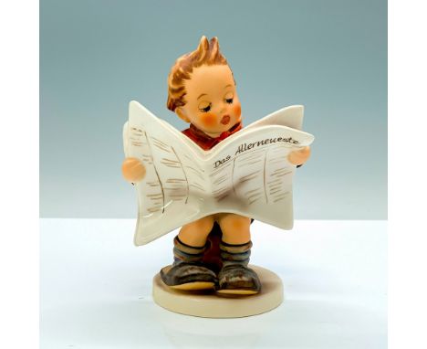 A figure of a young boy with an orange jacket and black shorts sitting on a wooden stool while reading a newspaper. Goebel Hu